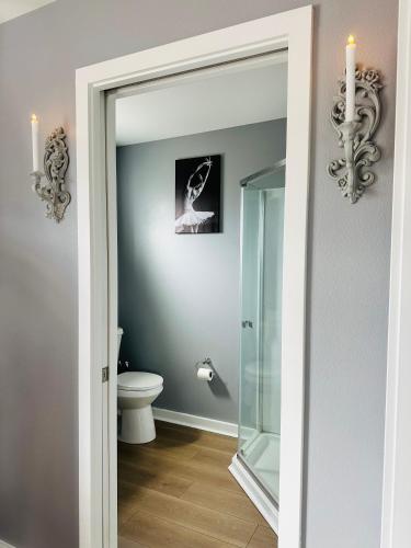 a bathroom with a toilet and a glass door at Audrey in Salem