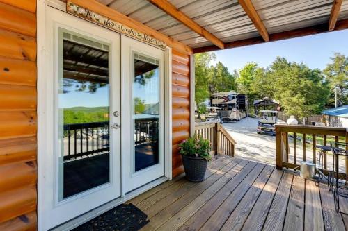 a front door of a wooden house with a porch at Indian Point Cabin 2 near SDC, Branson, and Table Rock Lake in Branson