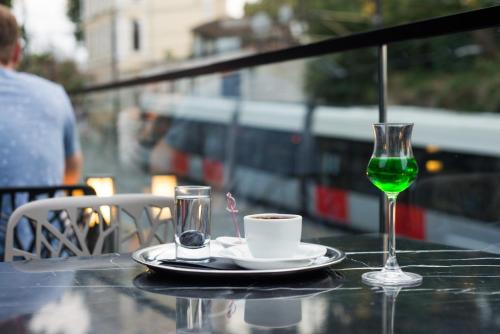 a table with a cup of coffee and a wine glass at Hotel Saint Sophia in Istanbul