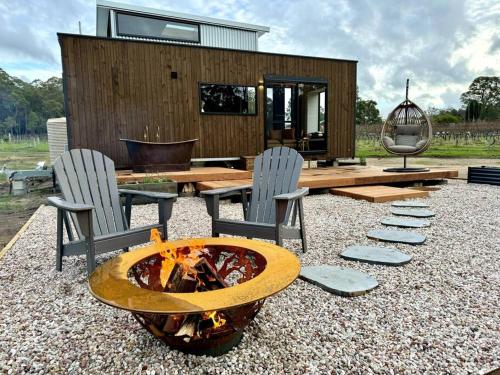a backyard with a fire pit and chairs and a house at The Soak at Dalton's Paddock in Manjimup