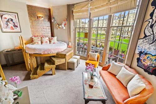 a living room with a bed and a large window at Hotel Pelirocco in Brighton & Hove