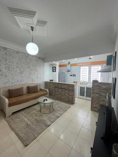 a living room with a couch and a table at Apartment Monastir Centre in Monastir