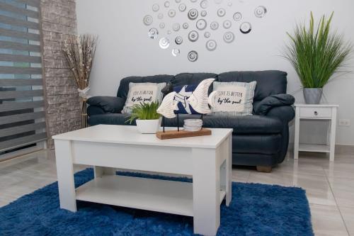 a living room with a couch and a white coffee table at Rocky point beach house. in Puerto Peñasco