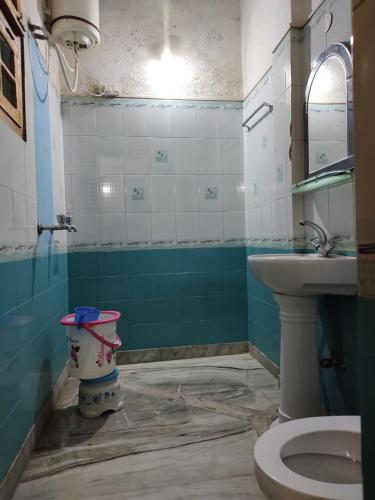 a bathroom with a toilet and a sink at HOTEL Cedar Heritage in Lohaghāt