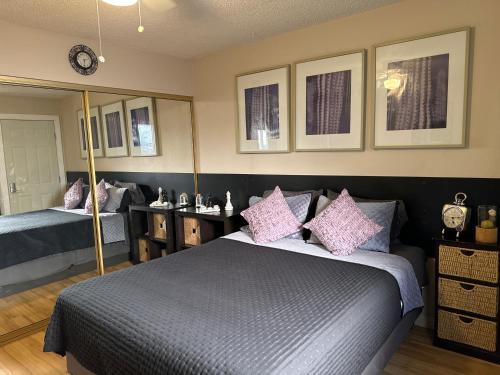 a bedroom with two beds with pink pillows at Le Noir, A private bedroom with a private entrance - shared bathroom in Las Vegas