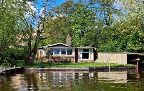 a house on an island in the middle of a river at Stunning Stacaravan In Reeuwijk in Reeuwijk