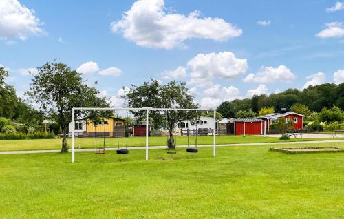 a swing set in a field of grass at 1 Bedroom Beautiful Home In Borås in Borås