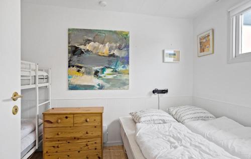 a bedroom with a bed and a painting on the wall at Terrassehus in Fæbæk