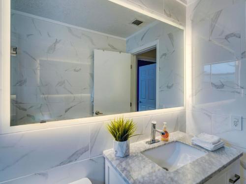 a white bathroom with a sink and a mirror at Luxury Miami Casa Bonita with Tropical Pool Oasis in Miami