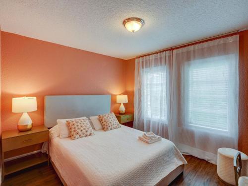 a bedroom with a bed and two lamps and a window at Luxury Miami Casa Bonita with Tropical Pool Oasis in Miami