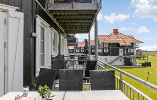 a balcony with tables and chairs on a house at Cozy Apartment In Bogense With Sauna in Bogense