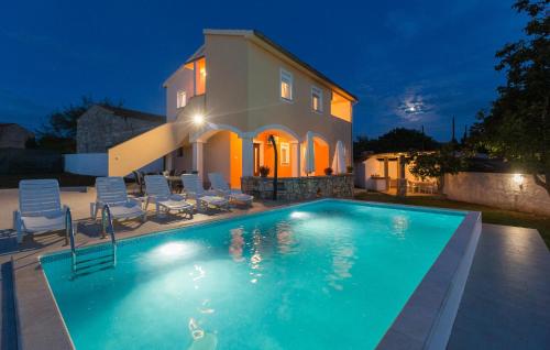 a swimming pool in front of a house at night at Awesome Home In Segotici in Šegotići