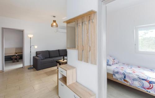 a small room with a bed and a couch at Awesome Home In Segotici in Šegotići