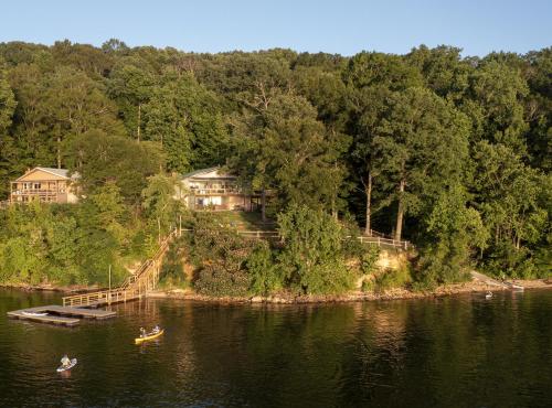 a couple of people in a boat in the water at Fox Berry Hill - Lakefront with Dock, Launch & Hot Tub in Waverly