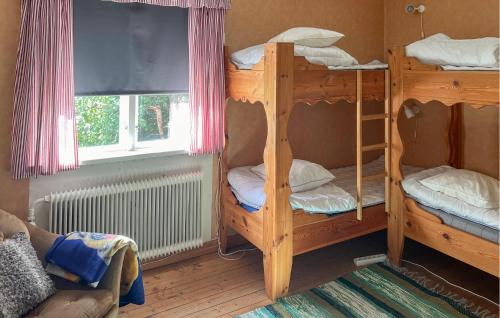 a room with two bunk beds and a window at 4 Bedroom Amazing Home In Sysslebäck in Sysslebäck