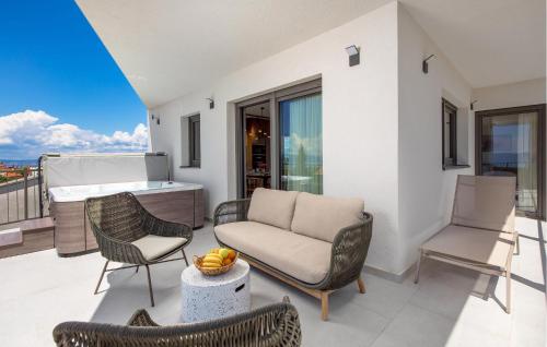 a living room with a couch and chairs on a balcony at Beautiful Apartment In Omisalj in Omišalj