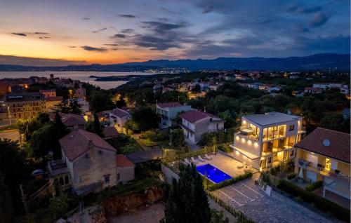 an aerial view of a house in a city at night at Amazing Apartment In Omisalj in Omišalj