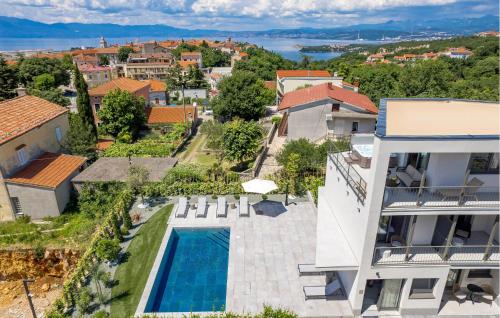 an aerial view of a house with a swimming pool at Amazing Apartment In Omisalj in Omišalj