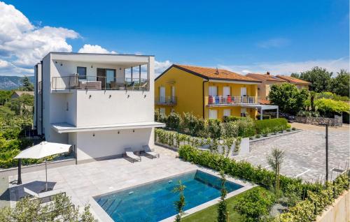 a villa with a swimming pool and a house at Amazing Apartment In Omisalj in Omišalj