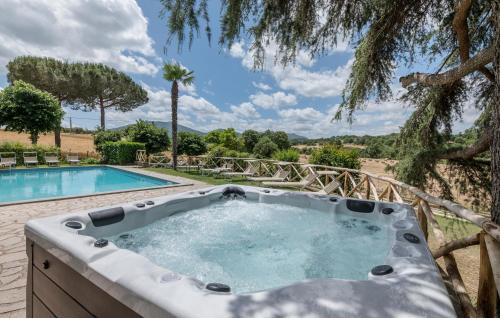 a hot tub in a garden next to a pool at Villa Arzilla in Vitorchiano