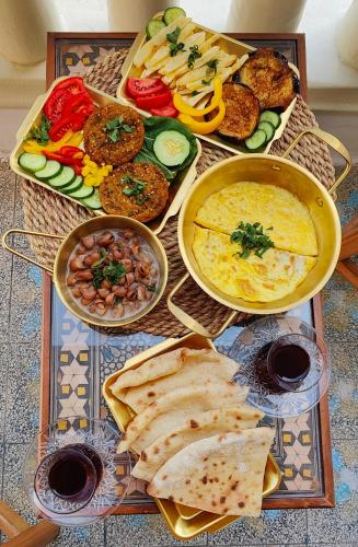 a table with different types of food on it at Champollion Palace in Cairo