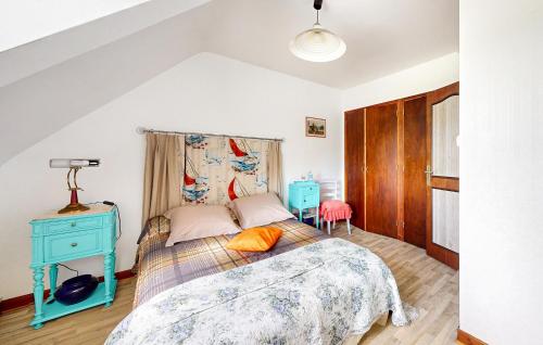 a bedroom with a bed and a blue night stand at Nice Home In Plouagat With Wifi in Plouagat