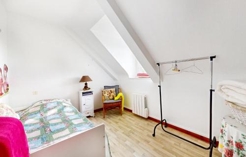 a white bedroom with a bed and a desk at Nice Home In Plouagat With Wifi in Plouagat