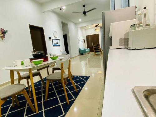 a kitchen with a table and chairs and a refrigerator at Alyn Home Klebang Netflix Coway Wifi in Melaka