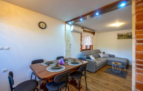 a living room with a table and chairs and a couch at Awesome Home In Zigrovec With Sauna in Sveti Ilija