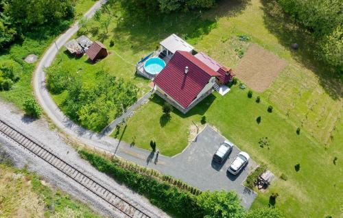 a man standing in front of a house with a yard at Awesome Home In Zigrovec With Sauna in Sveti Ilija
