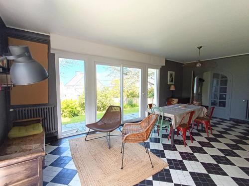 une salle à manger avec une table et des chaises dans une pièce dans l'établissement Maison à Perros-Guirec avec Jardin, Terrasse, Parking et Animaux Acceptés - FR-1-368-427, à Perros-Guirec
