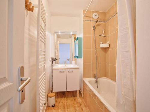 a bathroom with a white tub and a sink at Appartement familial à 250m du golf et de la plage, parking inclus - Varaville - FR-1-788-16 in Varaville