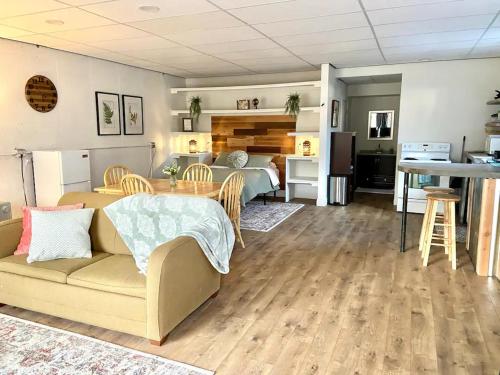 a living room with a couch and a bedroom at Suite Dreams in Cedar City
