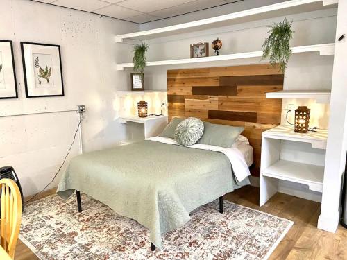a bedroom with a bed with a wooden headboard at Suite Dreams in Cedar City