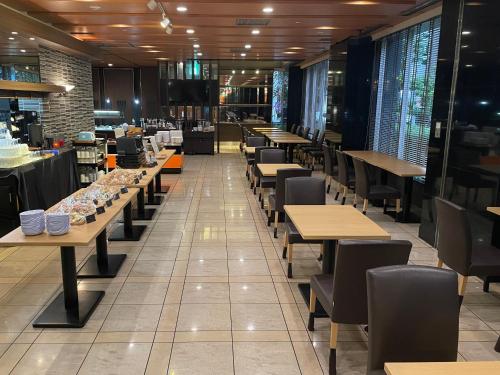 a row of tables and chairs in a restaurant at APA Hotel Nagoya Sakae in Nagoya