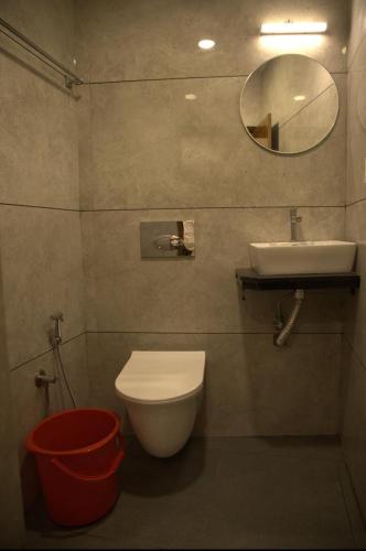 a bathroom with a sink and a toilet and a mirror at Hotel president park Coimbatore in Coimbatore