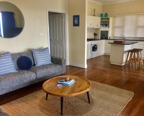 a living room with a couch and a coffee table at Esperance Central Apartments in Esperance
