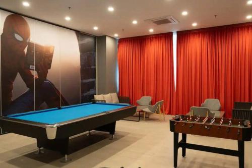 a room with a pool table and red curtains at Sky Trees Bukit Indah netflix and wifi in Johor Bahru
