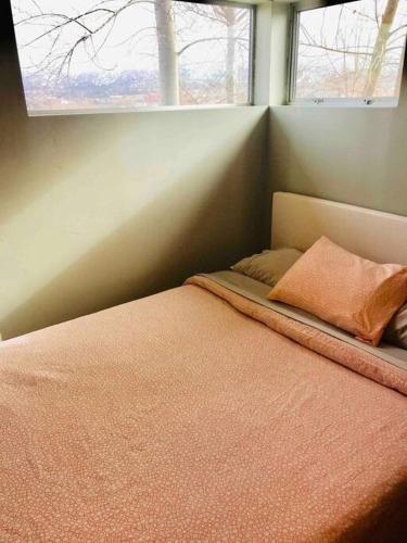 a bed in a room with a window at DREAMLOFT and PATIO on the HILL in Cedar City
