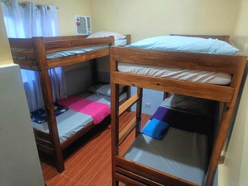 a couple of bunk beds in a room at Sevene Transient Inn in Puerto Princesa City
