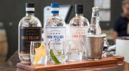three bottles of alcohol sitting on a wooden table at Avoca Park Equestrian Farmstay in Macclesfield