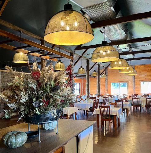 a dining room with tables and chairs and lights at Kangaroo Valley Golf and Country Retreat in Kangaroo Valley