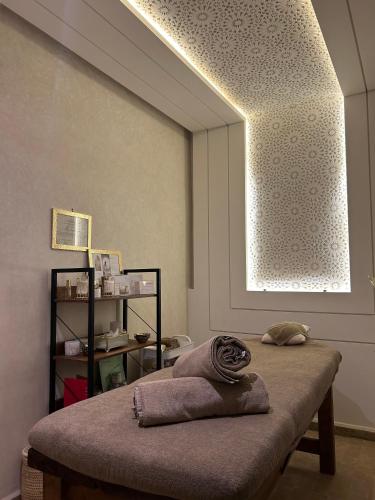 a room with a bed with a large window at Riad Luxe Nomade Marrakech & Spa in Marrakech