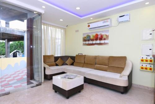 a living room with a couch and a table at Hotel Titanium Tower in Chennai
