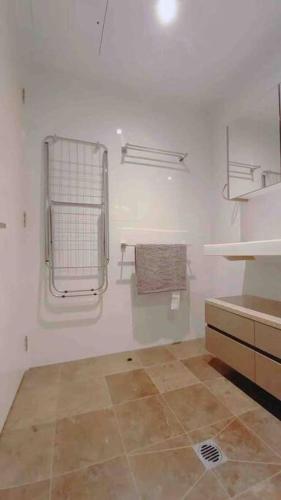 a bathroom with a sink and towels on the wall at City Comfy Apartment in Canberra