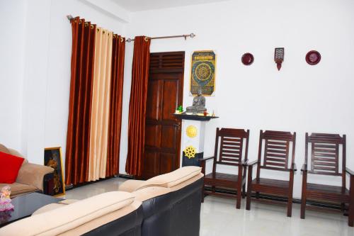 a living room with a couch and two chairs at Sasanda Villa and Yala Safari Place in Tissamaharama
