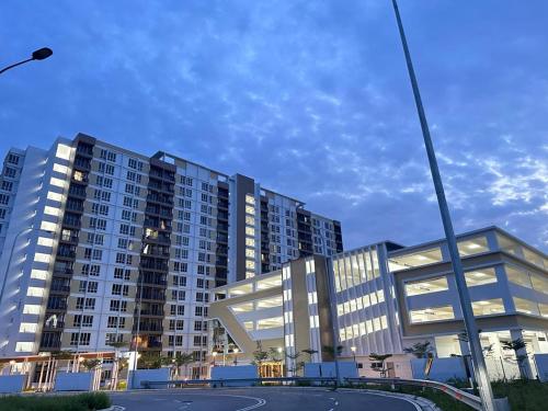 a large apartment building with a basketball court in front of it at Lylinz sierra heights in Pasir Gudang