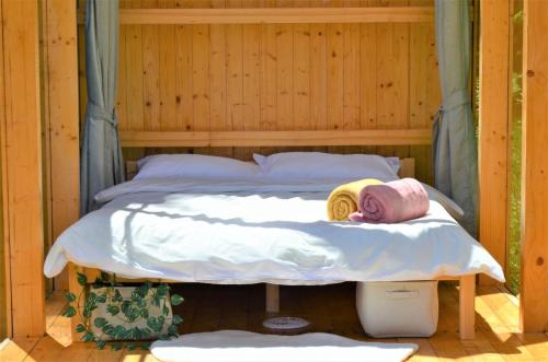 a bed in a wooden room with ahat on it at Starry Night Retreat in Subcetate