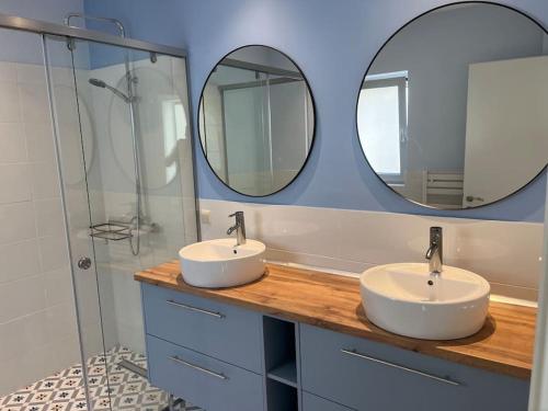 two sinks in a bathroom with two mirrors at Villa Infinia, Lefkada in Sivota