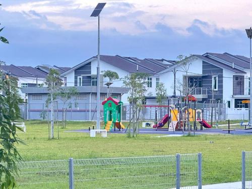 a park with a playground in front of a building at Lylinz bandar layangkasa in Kampong Kong Kong